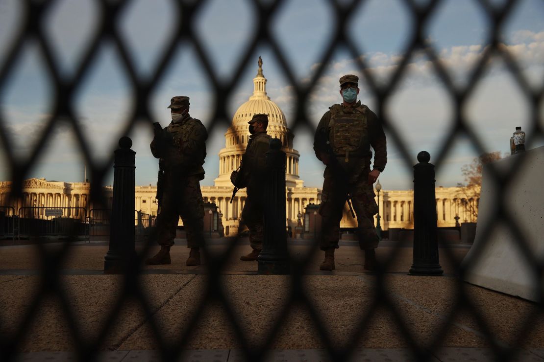 Members of the New York National Guard stand guard along the fence that surrounds the Capitol.