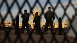 Members of the New York National Guard stand guard along the fence that surrounds the U.S. Capitol the day after the House of Representatives voted to impeach President Donald Trump for the second time January 14, 2021 in Washington, DC. 