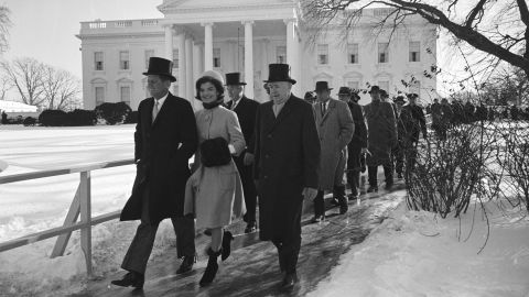 John F. Kennedy and Jacqueline Kennedy, along with others, walk to JFK's Inauguration Day ceremony in Washington, DC on January 20, 1961. 