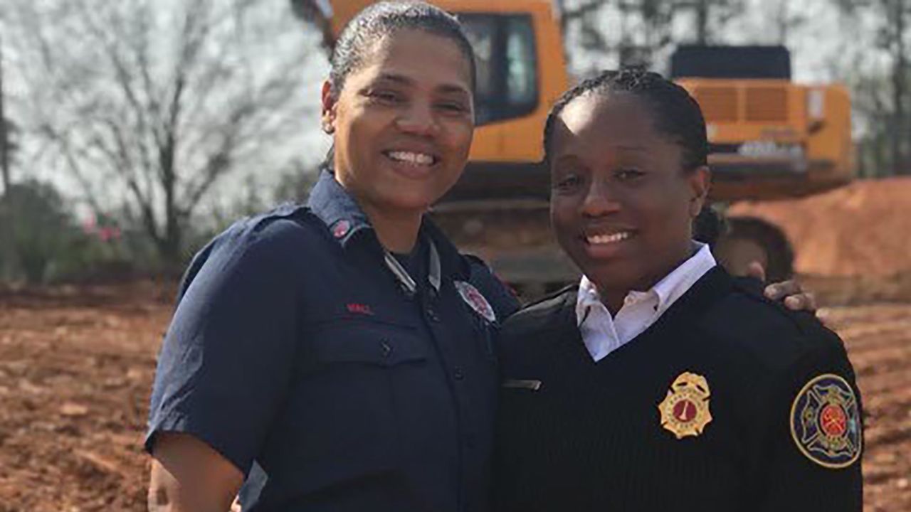 Andrea Hall, left, became the first Black woman to be named captain with the City of South Fulton Fire Rescue Department. She's pictured with her younger sister, Whitney Williams-Smith, the chief fire marshal for the Savannah Fire Department.