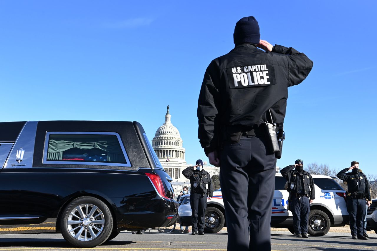 A hearse carrying the remains of <a href="https://www.cnn.com/2021/01/08/us/brian-sicknick-death/index.html" target="_blank">US Capitol police officer Brian Sicknick</a> passes along Third Street in Washington, DC, on Sunday, January 10. Sicknick was killed in the line of duty after a mob of President Trump's supporters invaded the US Capitol.
