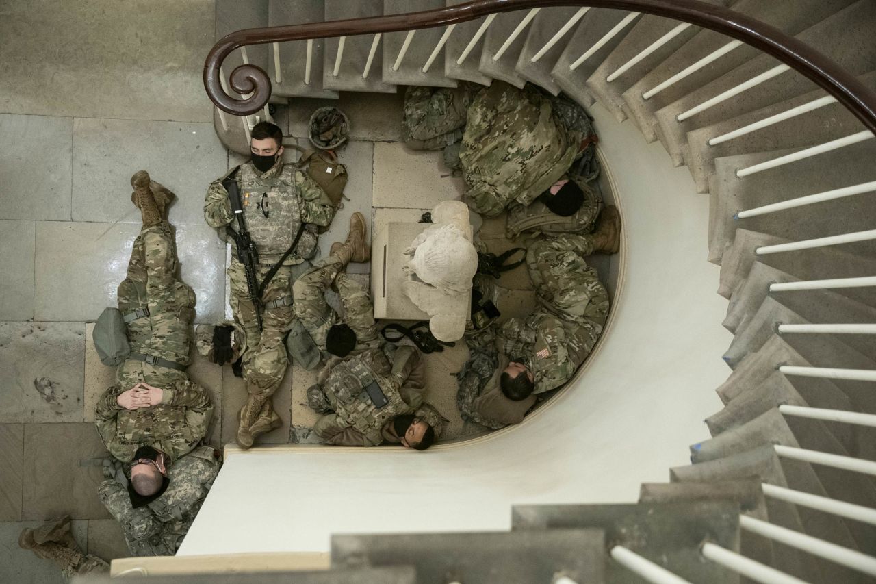 National Guard members rest in a hallway of the US Capitol in Washington, DC, on Wednesday, January 13. More than <a href="https://www.cnn.com/2021/01/13/politics/inauguration-security-us-secret-service-washington/index.html" target="_blank">20,000 National Guard members</a> are expected to be in the nation's capital to help secure President-elect Joe Biden's inauguration. 
