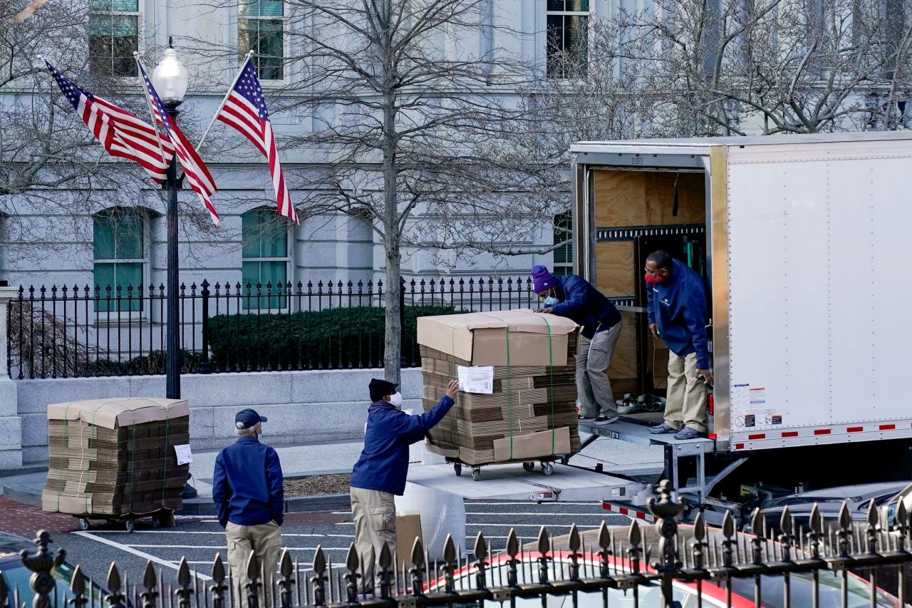 Workers unload pallets of cardboard boxes at the Executive Office Building on the White House grounds on Wednesday, January 13, in Washington, DC.