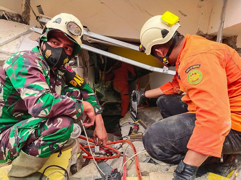 Rescuers search for victims under the rubble.