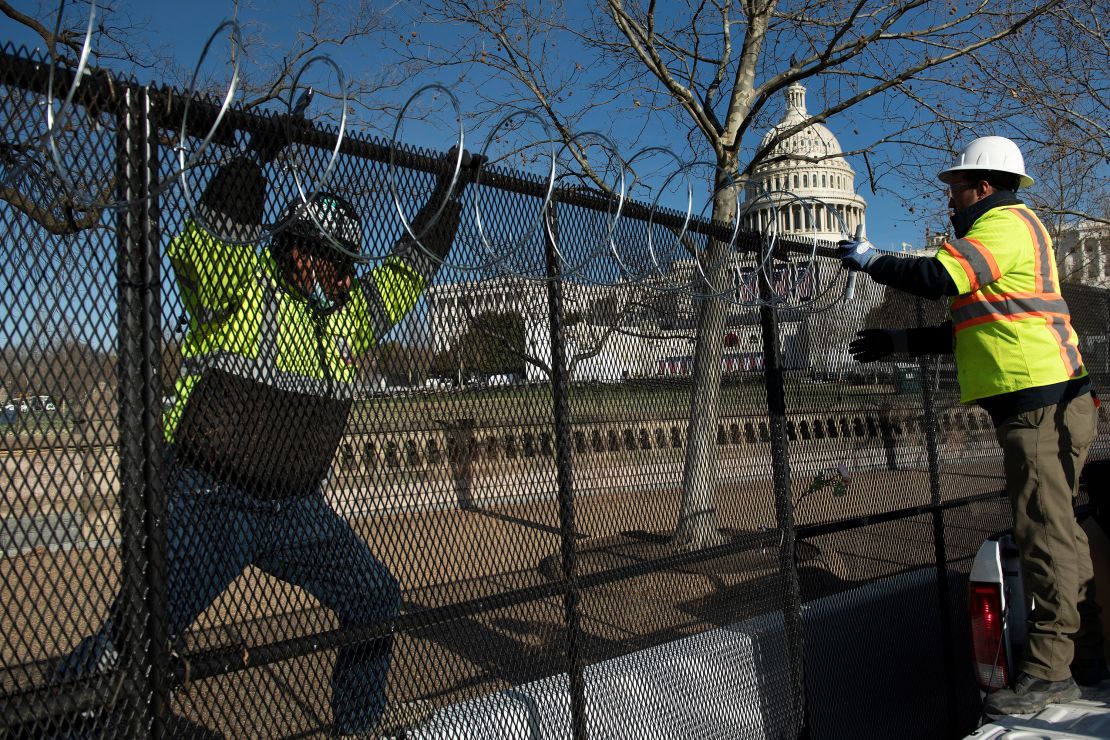 Razor wire is installed atop a security fence in preparation for next week's Presidential inauguration.