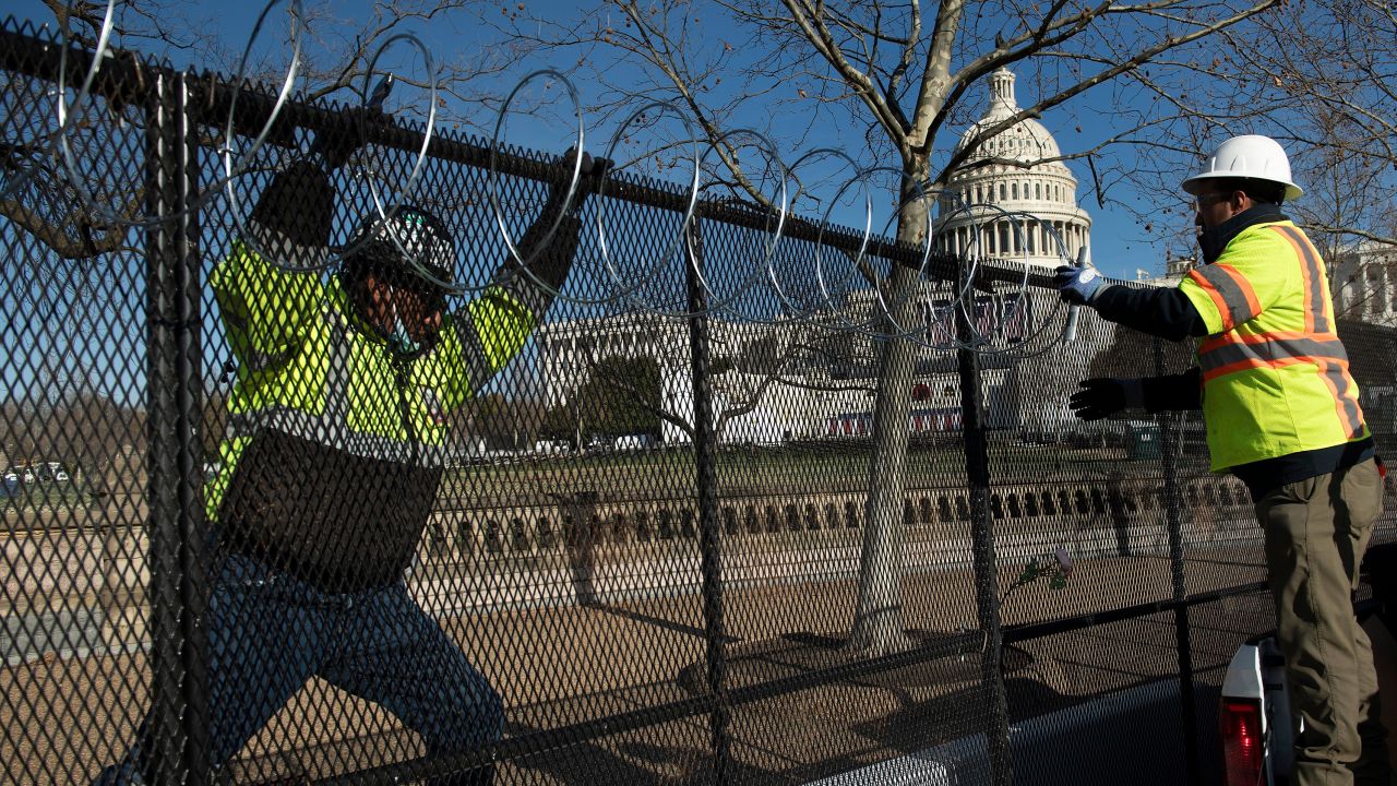 Razor wire is installed atop a security fence in preparation for next week's Presidential inauguration.