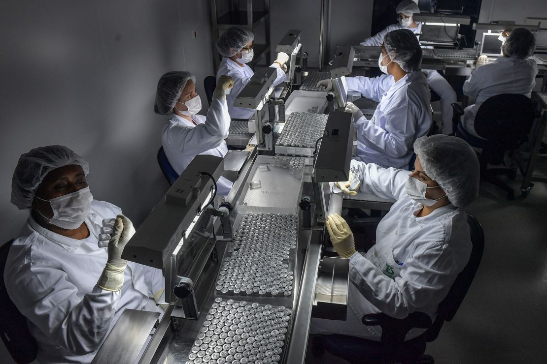 Employees work on the production line of CoronaVac, Sinovac Biotech's vaccine against Covid-19 coronavirus at the Butantan biomedical production center, in Sao Paulo, Brazil, on January 14, 2021. 