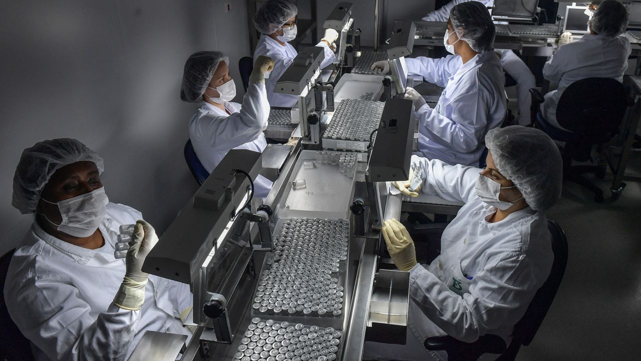 Employees work on the production line of CoronaVac, Sinovac Biotech's vaccine against Covid-19 coronavirus at the Butantan biomedical production center, in Sao Paulo, Brazil, on January 14, 2021. 