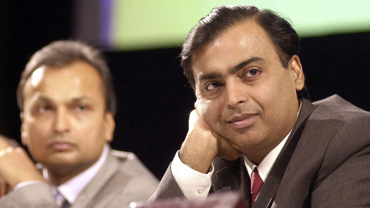 India's largest private sector company Reliance Industries Chairman and Managing Director Mukesh Ambani (R) along with then Vice Chairman Anil Ambani listen to shareholders opinions at the company's Annual General Meeting in Mumbai on June 24, 2004. 