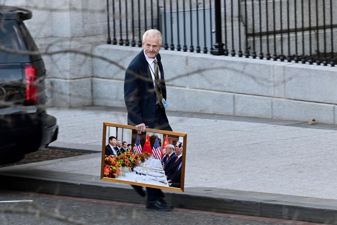 Navarro leaves the West Wing of the White House carrying a framed photograph on Jan 13, 2021. 