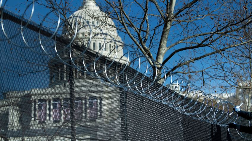 Razor wire is installed atop a security fence in preparation for next week's Presidential inauguration a week after a pro-Trump mob broke into and took over the Capitol, January 14, 2021, in Washington, DC. - The center of Washington was on lockdown Thursday as more than 20,000 armed National Guard troops were being mobilized due to security concerns ahead of the presidential inauguration of Joe Biden. (Photo by Brendan Smialowski/AFP/Getty Images)