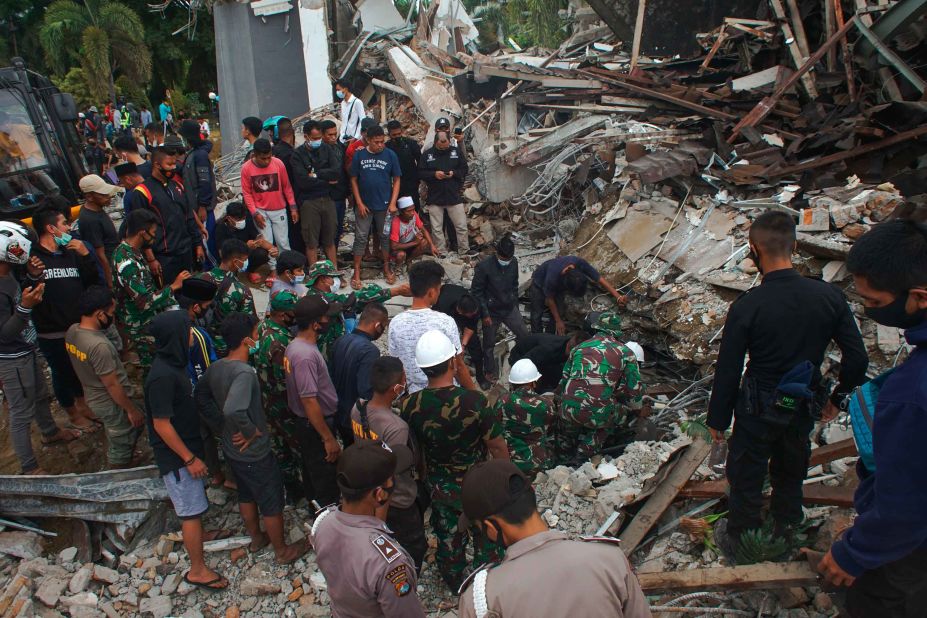 Rescuers search for survivors under a government building that collapsed during an earthquake in Mamuju, West Sulawesi, Indonesia, on Friday, January 15.