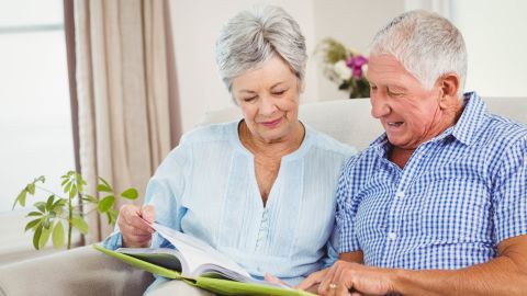 underscored older senior couple reading book documents