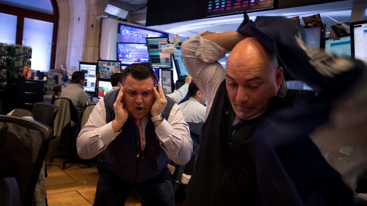 Traders work on the floor of the New York Stock Exchange on March 12, 2020.
