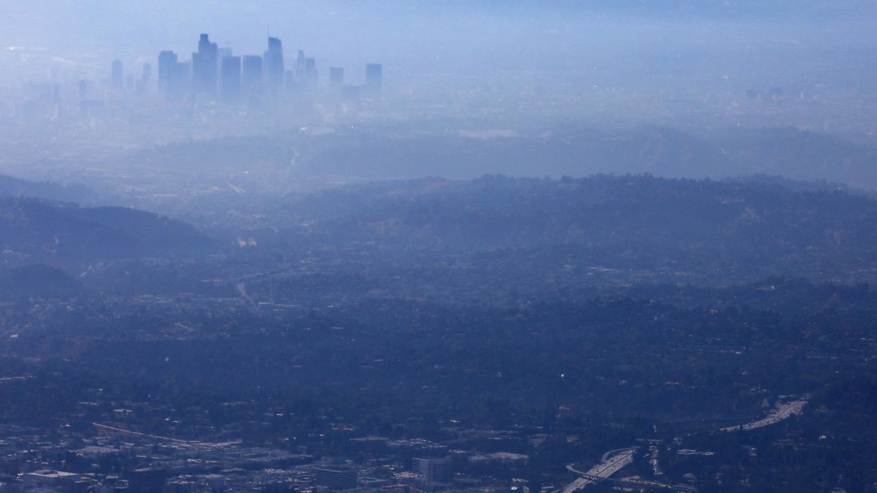 The buildings of downtown Los Angeles are partially obscured at midday on November 5, 2019.