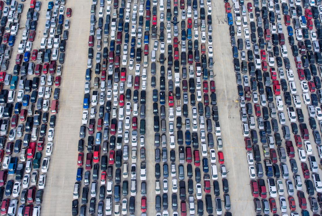 People wait in their cars for the San Antonio Food Bank to begin distributing food on April 9, 2020. 