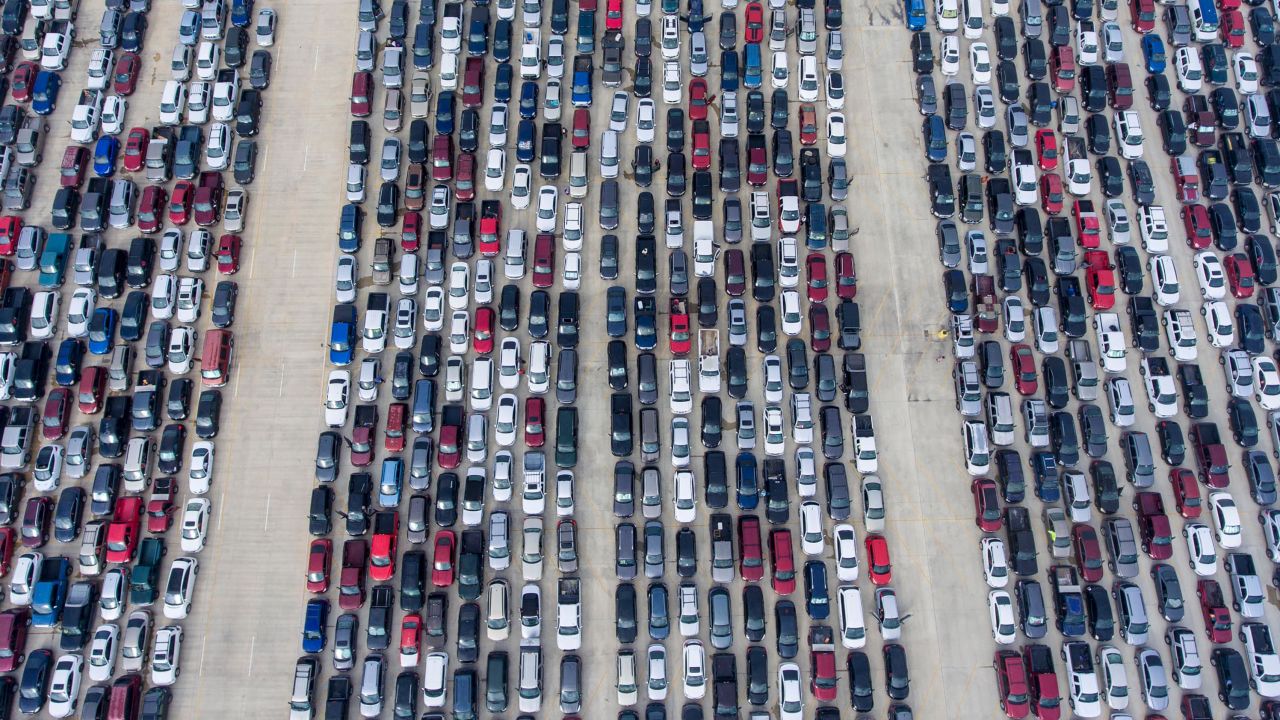 People wait in their cars for the San Antonio Food Bank to begin distributing food on April 9, 2020.