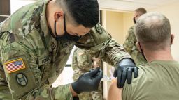 Members of the West Virginia National Guard conduct and participate in a COVID-19 vaccination clinic at Joint Forces Headquarters, Charleston, West Virginia, Jan. 13, 2021. West Virginia maintains one of the highest percentages of vaccine allocation use in the United States and is rapidly expanding capacity to inoculate the population.