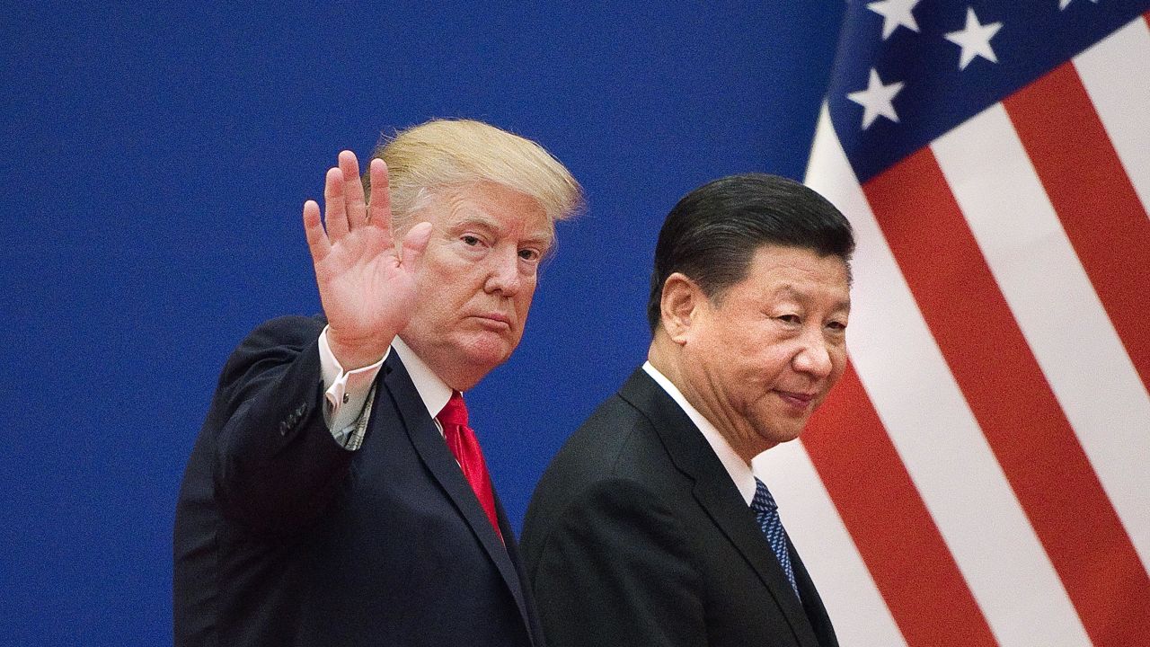 US President Donald Trumpand China's President Xi Jinping leave a business leaders event at the Great Hall of the People in Beijing on November 9, 2017.