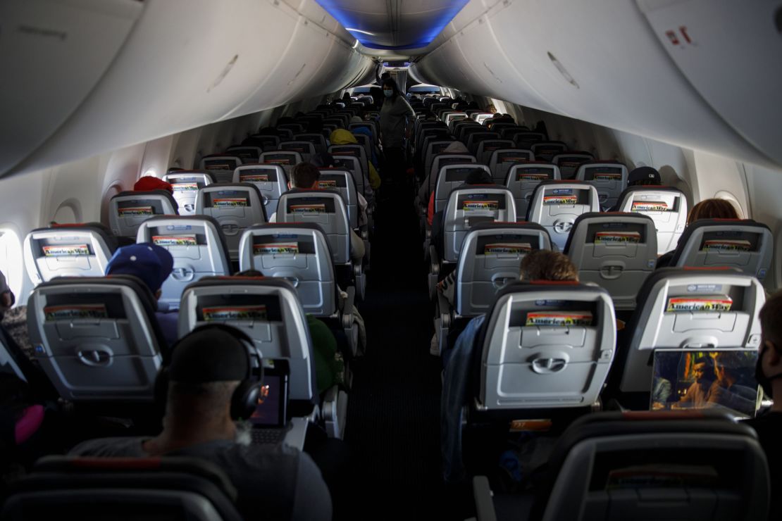 Passengers wear protective masks on an American Airlines flight departing Los Angeles International Airport on June 13, 2020. 