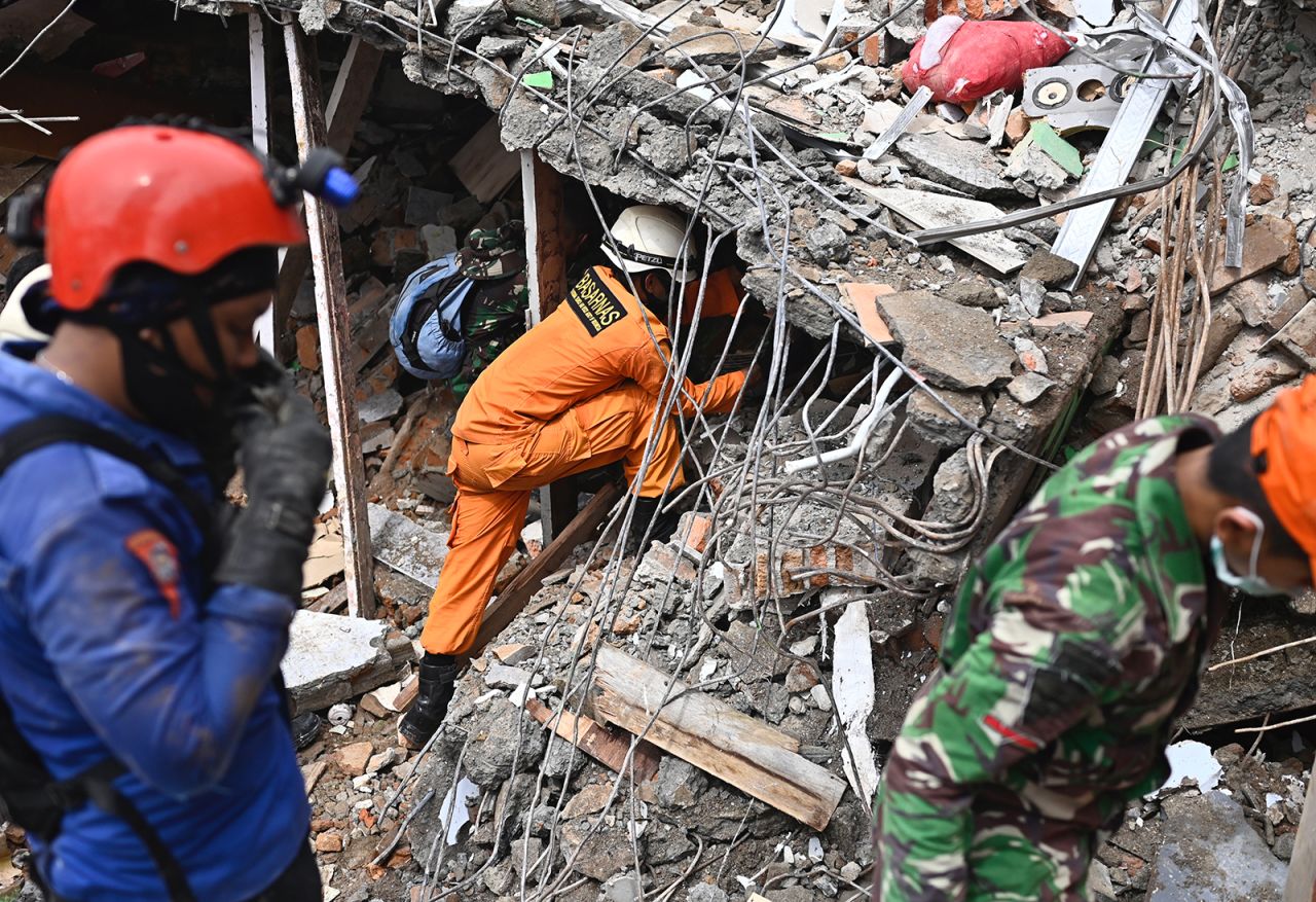 Rescuers search for survivors in a collapsed building in Mamuju, West Sulawesi, Indonesia, on Saturday, January 16.