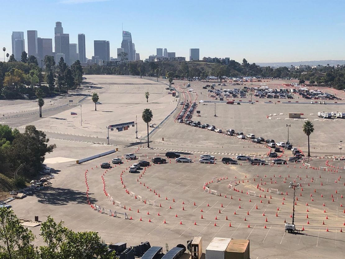Medical workers in their cars await Covid-19 vaccinations at a Dodger Stadium parking lot. On Friday, the stadium began its new role as a vaccination hub.