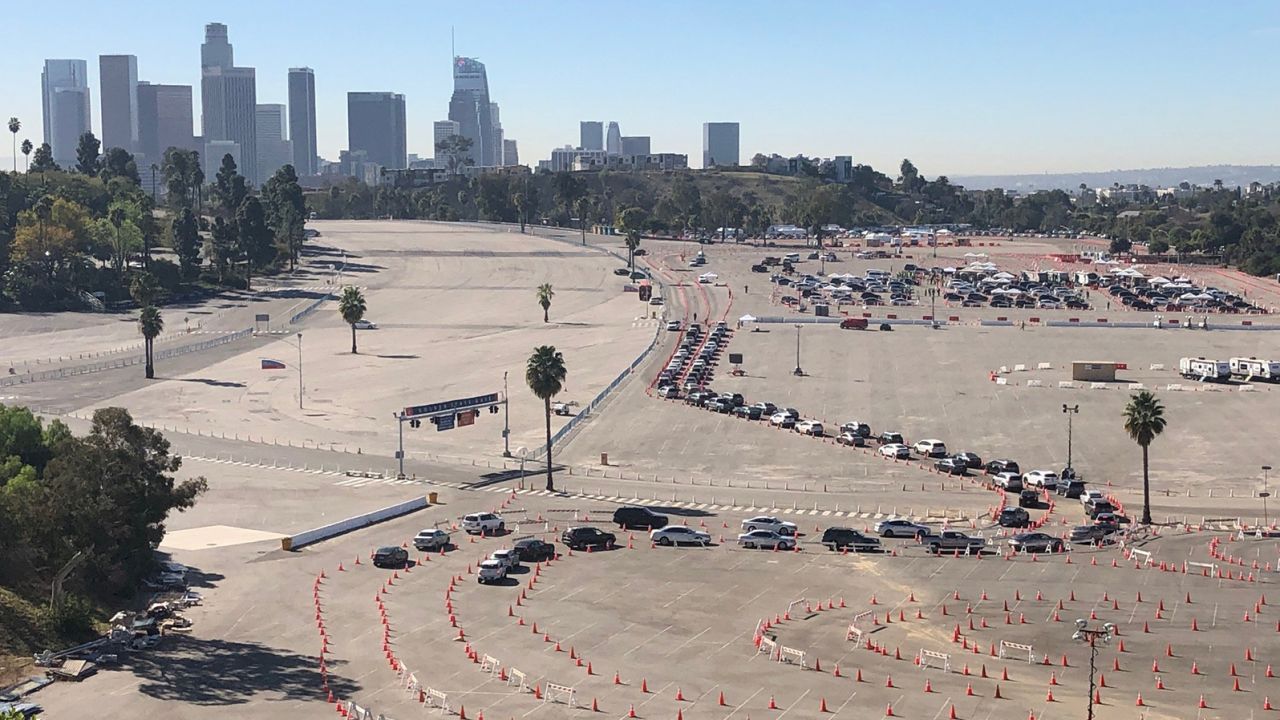 Medical workers in their cars await Covid-19 vaccinations at a Dodger Stadium parking lot. On Friday, the stadium began its new role as a vaccination hub.