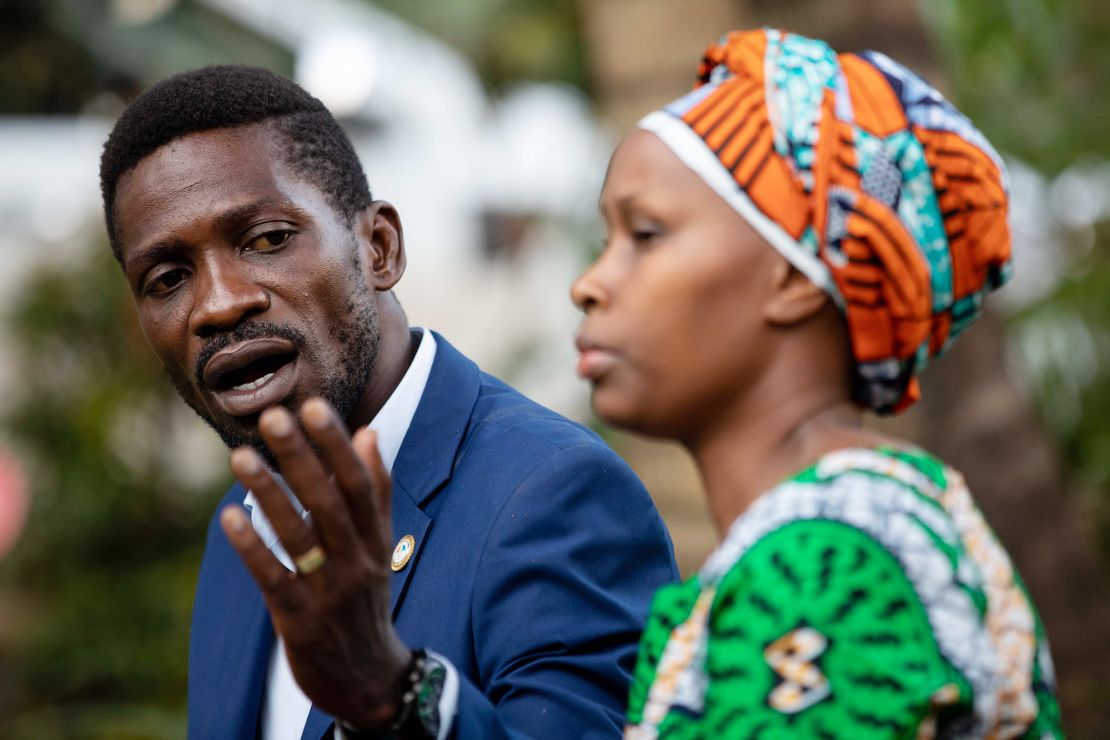 Bobi Wine, left, addresses the media with his wife, Barbara Itungo Kyagulanyi, as security forces surround his home on Friday in Kampala, Uganda.