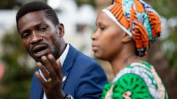 Bobi Wine addresses the media next to his wife wife Barbara Itungo Kyagulanyi as security forces surround his home