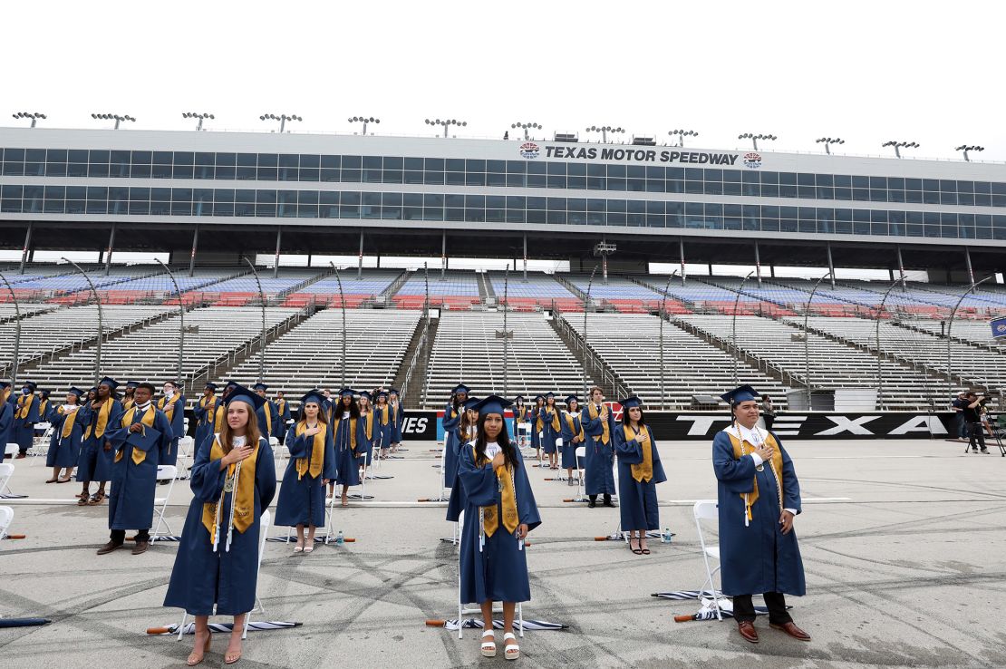 Little Elm High School graduates stand six feet apart from each other during graduation ceremonies at Texas Motor Speedway in Fort Worth on May 21.
