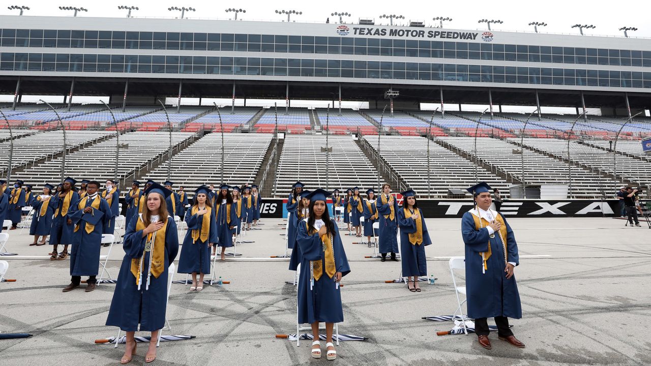 Little Elm High School graduates stand six feet apart from each other during graduation ceremonies at Texas Motor Speedway in Fort Worth on May 21.