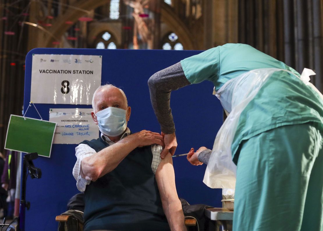 Former RAF Flight Sergeant Louis Godwin receives an injection of the Pfizer coronavirus vaccine at Salisbury Cathedral, Wiltshire. 