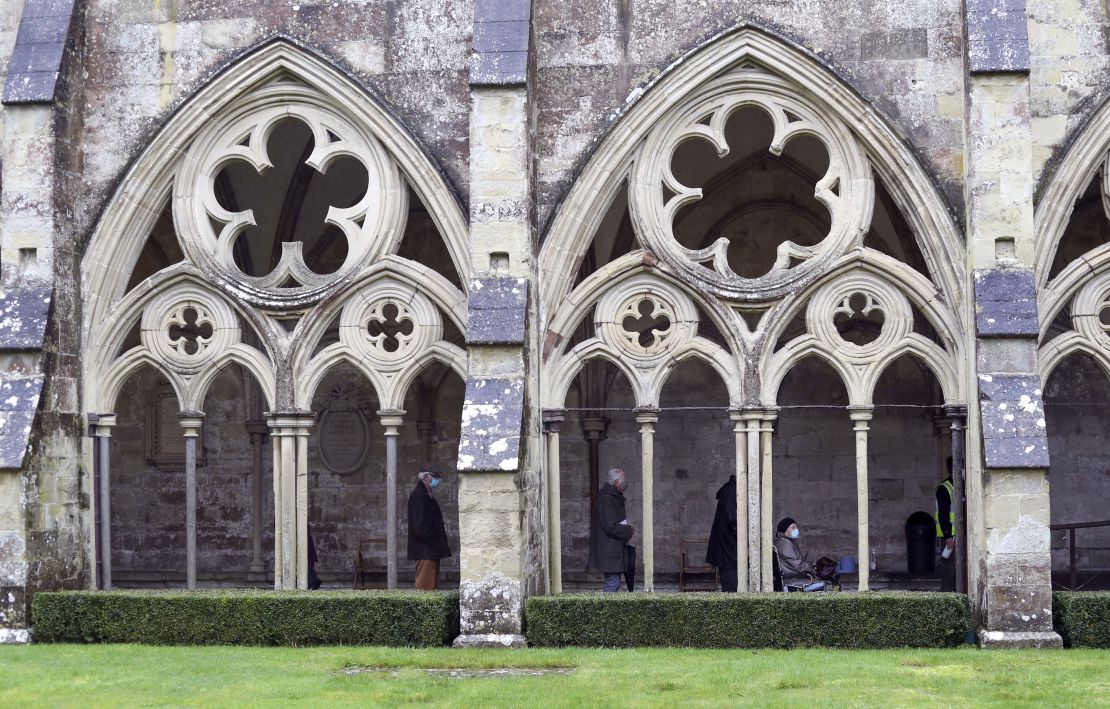People queue outside Salisbury Cathedral, Wiltshire, to recieve an injection of the Pfizer coronavirus vaccine.