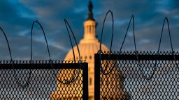 WASHINGTON, DC - JANUARY 16: The U.S. Capitol is seen behind a fence with razor wire during sunrise on January 16, 2021 in Washington, DC. After last week's riots at the U.S. Capitol Building, the FBI has warned of additional threats in the nation's capital and in all 50 states. According to reports, as many as 25,000 National Guard soldiers will be guarding the city as preparations are made for the inauguration of Joe Biden as the 46th U.S. President. (Photo by Samuel Corum/Getty Images)