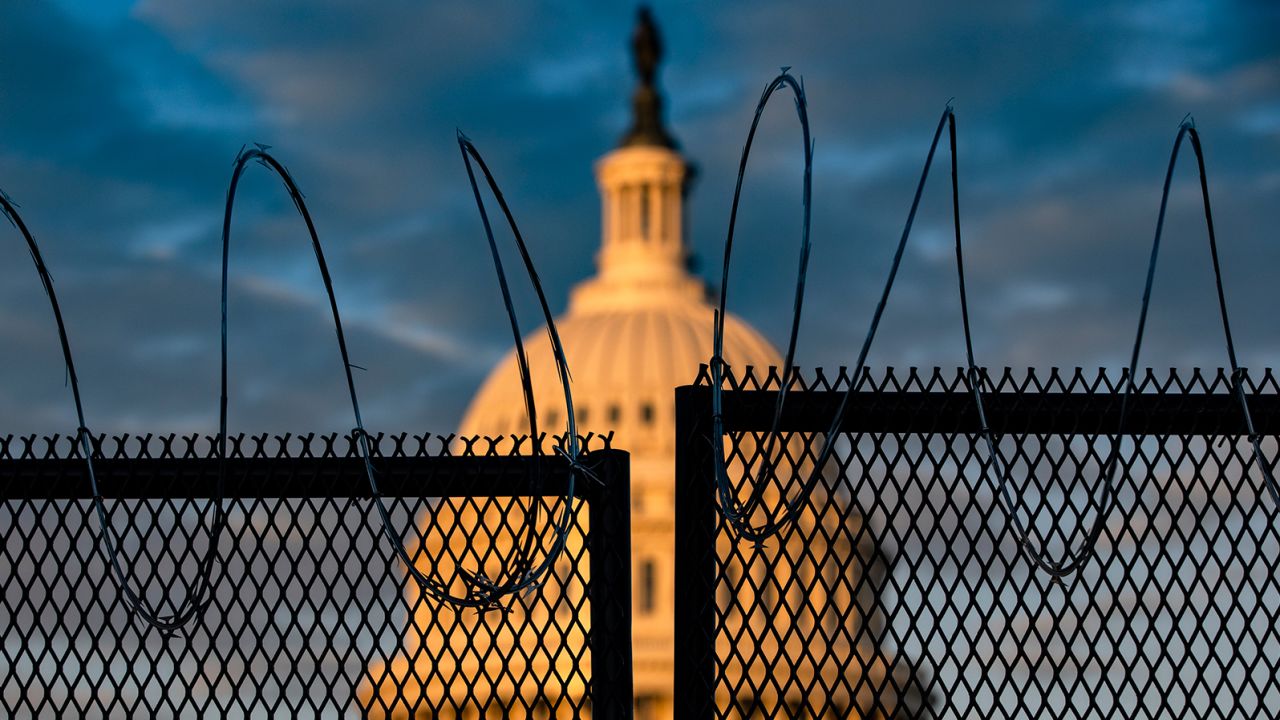 The US Capitol is seen behind a fence topped with razor wire on Saturday in Washington.