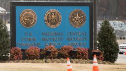 A sign for the National Security Agency (NSA), US Cyber Command and Central Security Service, is seen near the visitor's entrance to the headquarters of the National Security Agency (NSA) after a shooting incident at the entrance in Fort Meade, Maryland, February 14, 2018. - Shots were fired early Wednesday at the ultra-secret National Security Agency, the US electronic spying agency outside Washington, leaving one person injured, officials said.Aerial footage of the scene from NBC News showed a black SUV with numerous bullet holes in its windshield crashed into concrete barriers at the main entrance to the NSA's headquarters in Fort Meade, Maryland. (Photo by SAUL LOEB / AFP) (Photo by SAUL LOEB/AFP via Getty Images)