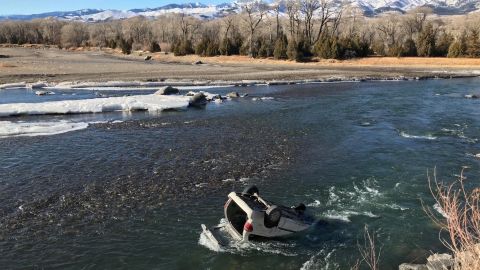 Trooper Connor Wager tethered himself with a rope before entering the "nearly freezing" Yellowstone River, the Montana Highway Patrol said.