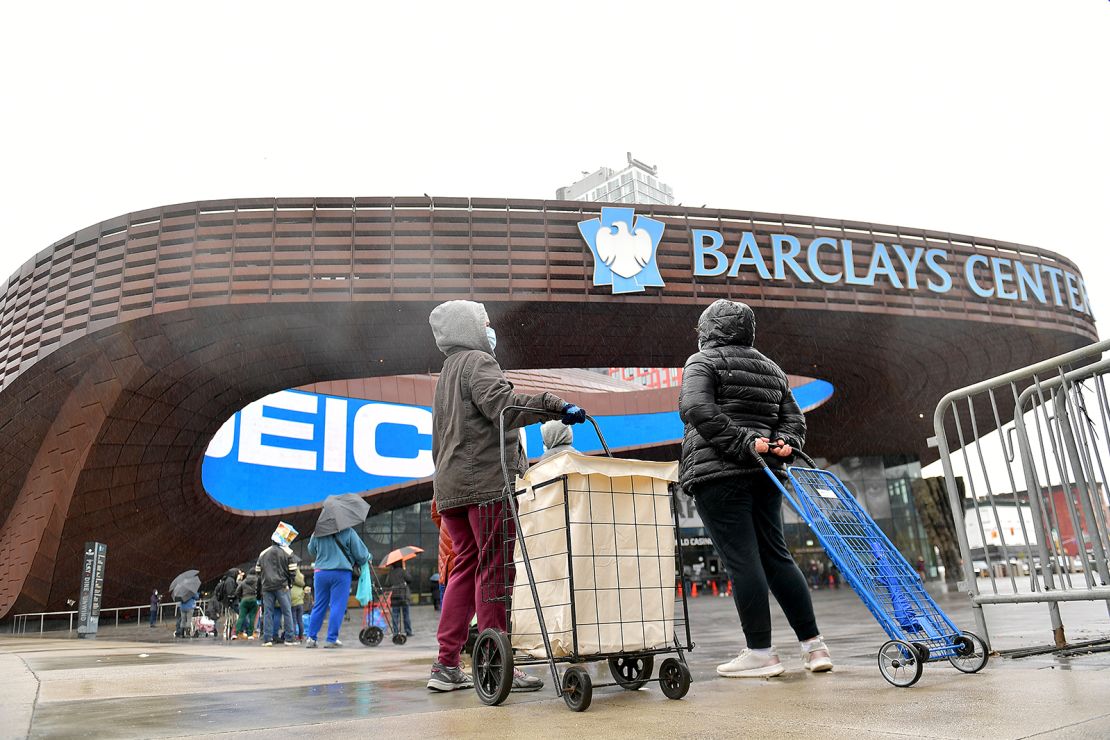 People await access to a mobile food pantry at Barclays Center in Brooklyn, New York, on April 24.