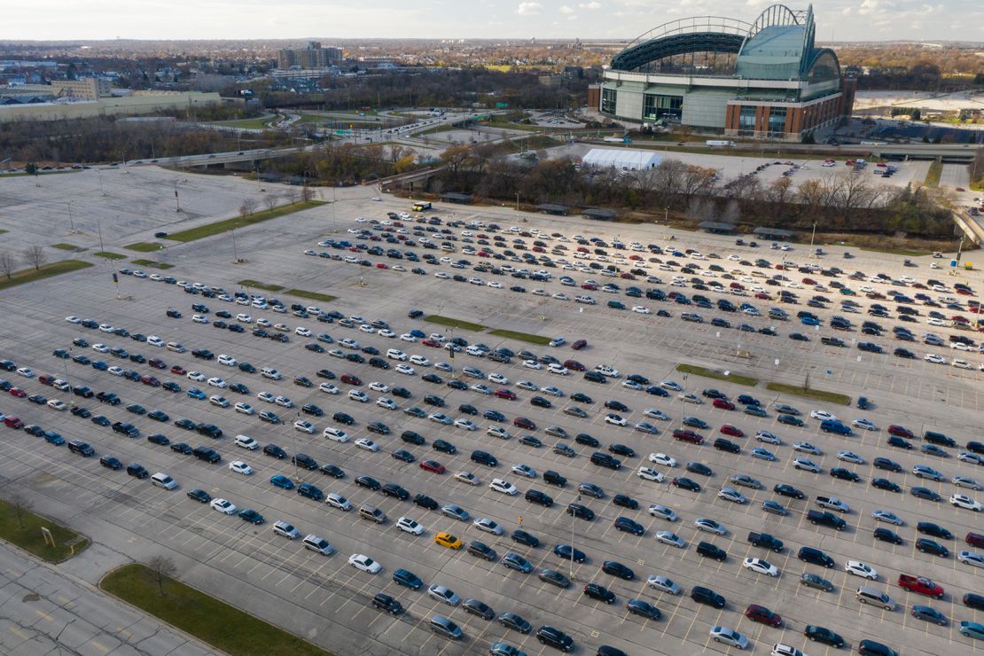 People in vehicles wait to enter a drive-thru Covid-19 testing site at Miller Park in Milwaukee, Wisconsin.