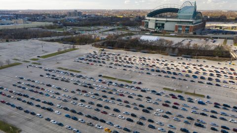 People in vehicles wait to enter a drive-thru Covid-19 testing site at Miller Park in Milwaukee, Wisconsin.