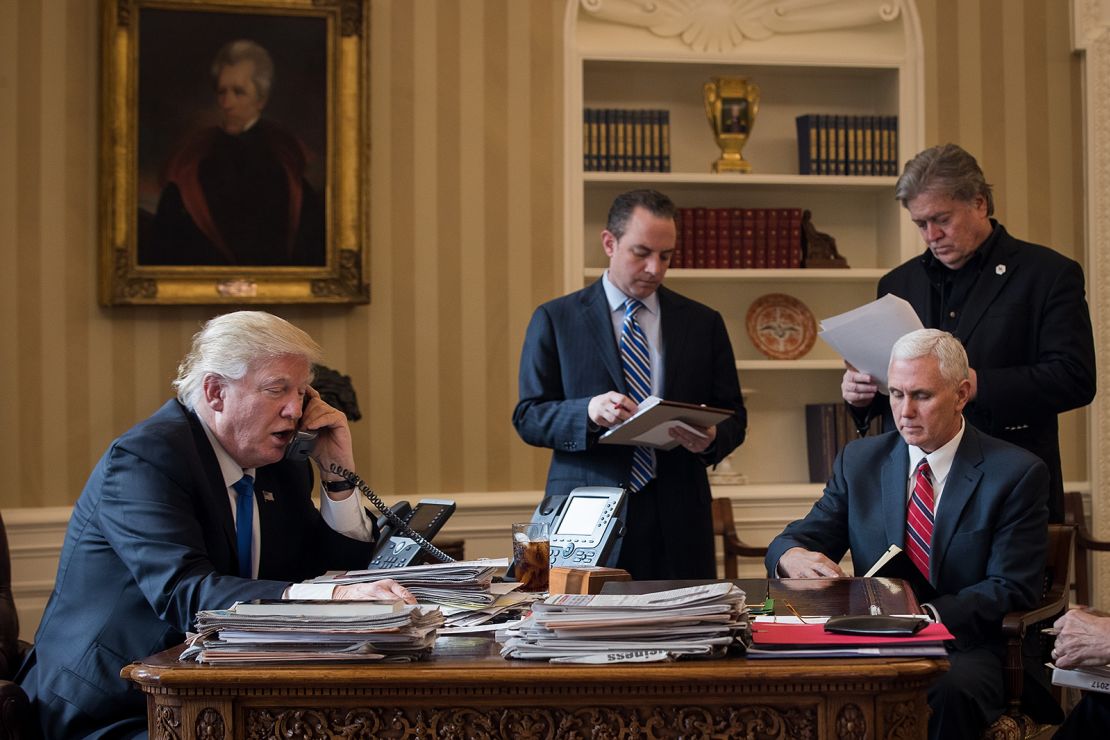 President Donald Trump speaks on the phone with Russian President Vladimir Putin in the Oval Office of the White House, January 28, 2017