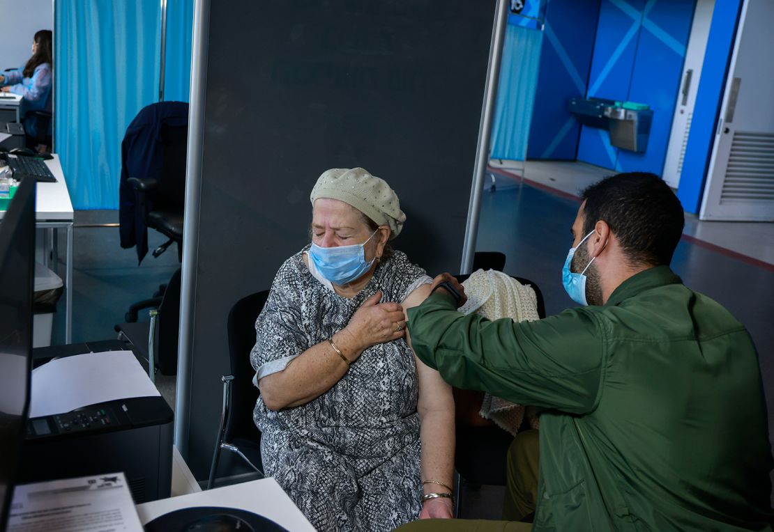 A health care worker administers a vaccine in Jerusalem, on January 6.