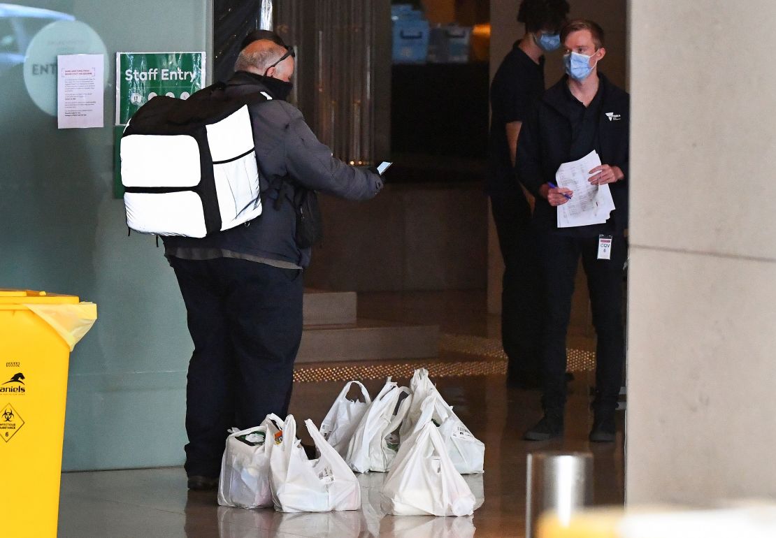 A food delivery worker delivers food to a hotel in Melbourne on January 17, 2021, where players are quarantining for two weeks ahead of the Australian Open tennis tournament.