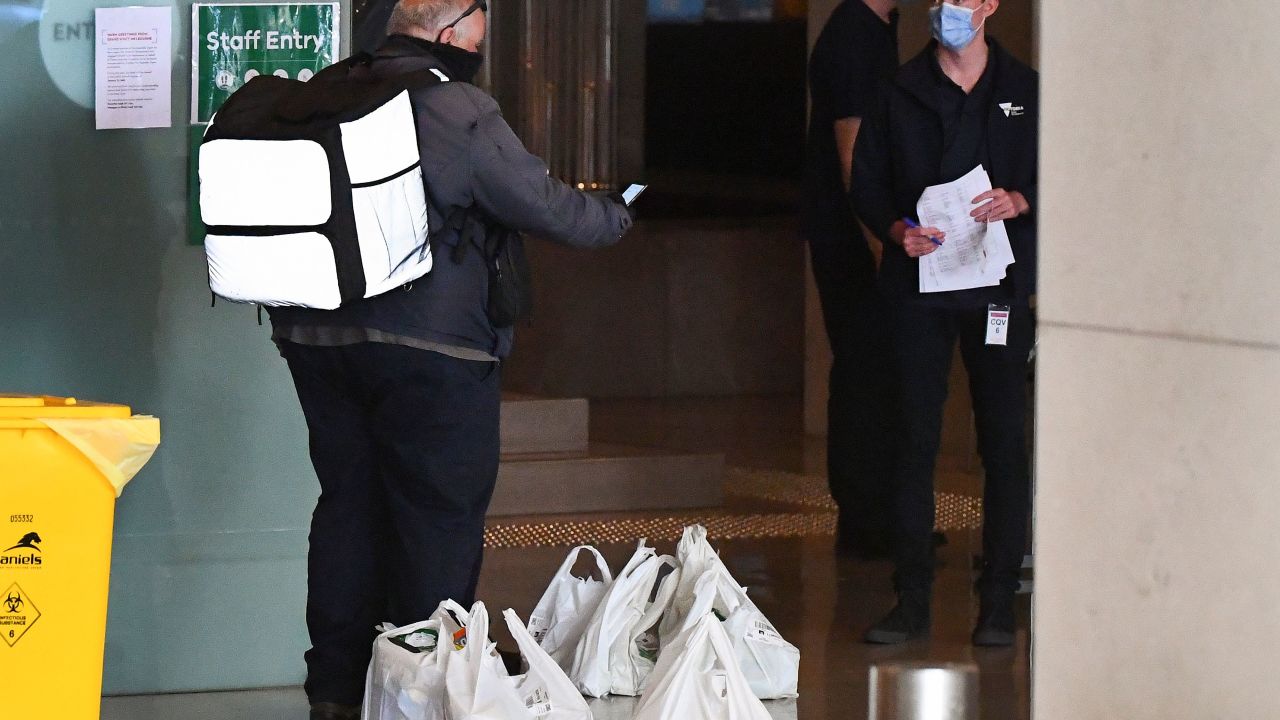 A food delivery worker delivers food to a hotel in Melbourne on January 17, 2021, where players are quarantining for two weeks ahead of the Australian Open tennis tournament.