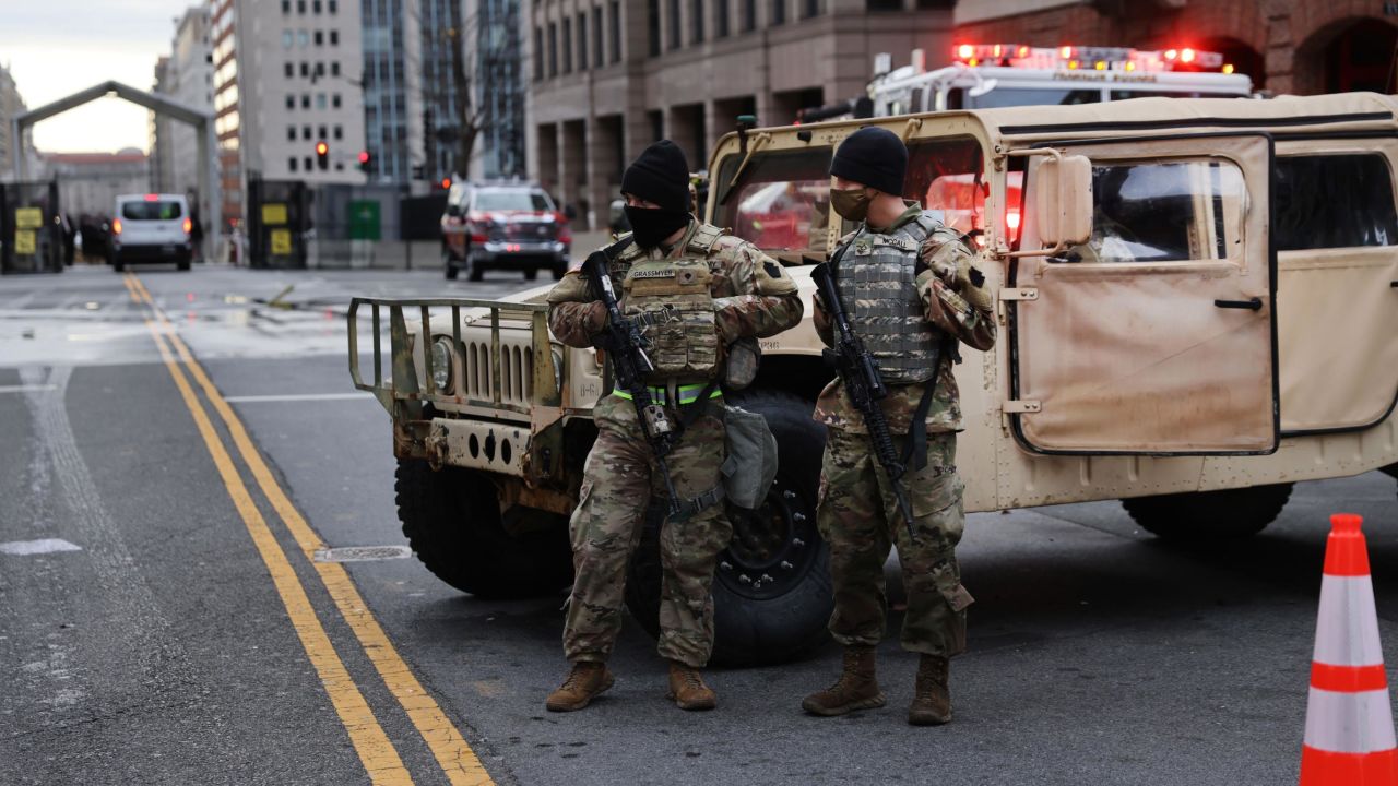 Members of the National Guard stand watch Sunday on a street in Washington, DC.