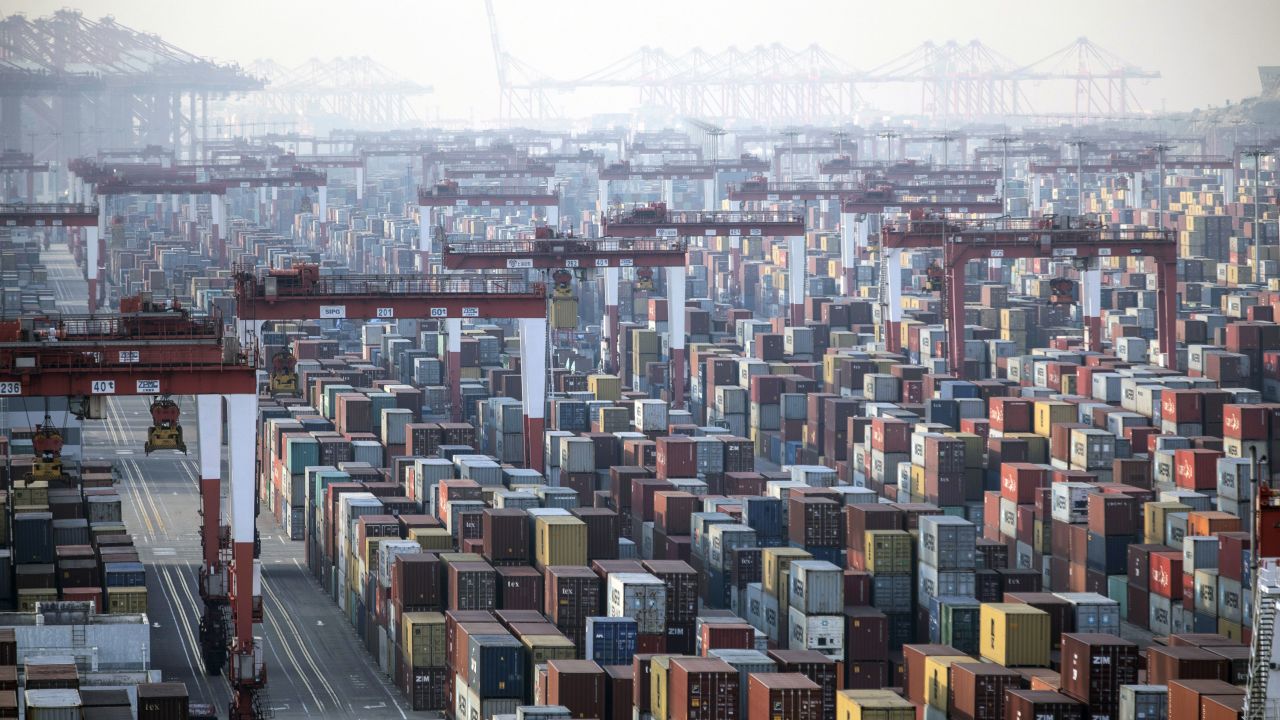 Shipping containers next to gantry cranes at the Yangshan Deepwater Port in Shanghai, China, on Monday, Jan, 11, 2021. U.S. President?Donald Trump?famously?tweeted?that "trade wars are good, and easy to win" in 2018 as he began to impose tariffs on about?$360 billion of imports?from China. Turns out he was wrong on both counts. Photographer: Qilai Shen/Bloomberg via Getty Images