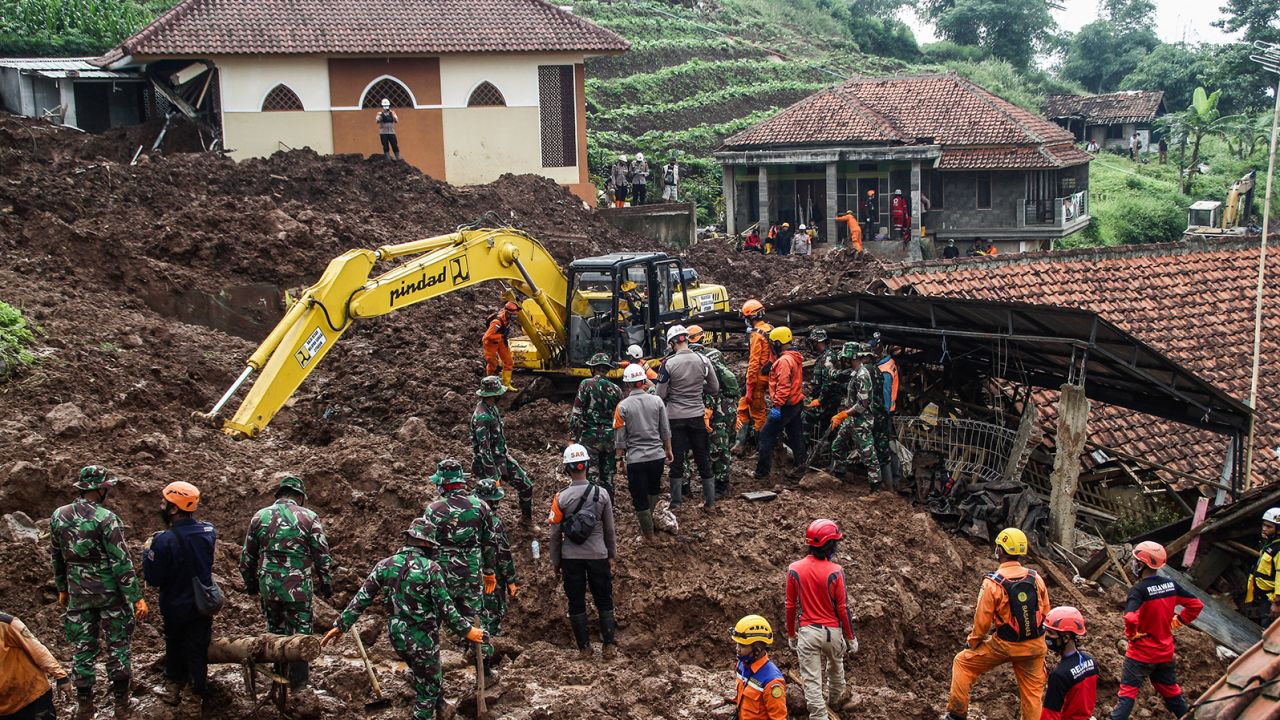 Rescue teams search for victims buried by the landslides in Cihanjuang Village, West Java. 