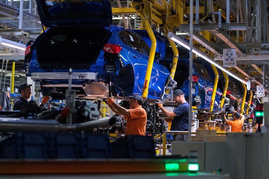 Workers fit Focus chassis inside the Ford factory in Saarlouis, Germany, in 2019.
