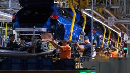 Workers fit Ford Focus automobile chassis inside the Ford Motor Co. factory in Saarlouis, Germany, on Wednesday, Sept. 25, 2019.