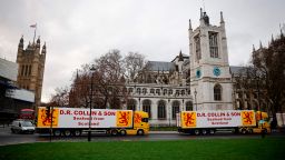 Lorries from Scottish seafood companies drive past the Houses of Parliament in a protest action by fishermen against post-Brexit red tape and coronavirus restrictions, which they say could threaten the future of the industry, in London on January 18, 2021. (Photo by Tolga Akmen/AFP/Getty Images)